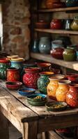 Vibrant Hand-Painted Pottery Collection on Rustic Wooden Table photo