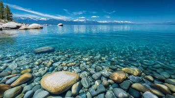 Crystal Clear Waters A Serene Landscape of Lake, Mountains, and Stones - A Scenic View of Nature's Beauty with Turquoise Water and Snow-Capped Peaks photo