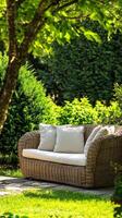Serene Garden Retreat Wicker Sofa with Cushions Amidst Lush Greenery - A Tranquil Outdoor Oasis for Relaxation and Peaceful Leisure photo