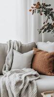Cozy Comfort A Serene Couch Scene with Pillows, Blanket, and Natural Light, Perfect for Home Decor and Relaxation in a Modern Living Space photo