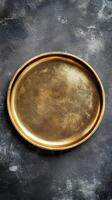 Elegant Golden Tray on Dark Textured Background - A Versatile Graphic Resource for Design, Decoration, and Artistic Projects, Offering a Touch of Vintage Charm photo