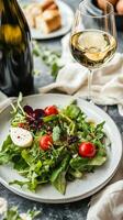 A Vibrant Salad Symphony Fresh Greens, Cherry Tomatoes, and Creamy Mozzarella Paired with Crisp White Wine for a Delightful Culinary Experience photo