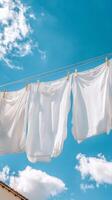 Whimsical White Laundry Draped Against a Vibrant Azure Sky photo