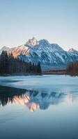 Majestic Winter Mountain Reflection on Frozen Lake photo