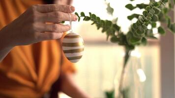 A person holding an egg with a gold stripe on it video