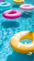 Bright pool floats in sparkling blue water photo
