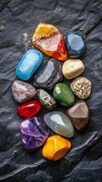 Colorful Gemstones on Dark Slate Background photo