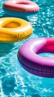 Colorful Inflatable Rings in a Sparkling Pool photo