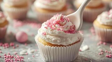 Delicate Pink Sprinkles on Creamy Cupcakes photo