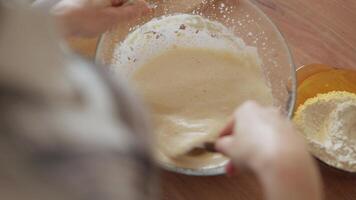 A person is mixing ingredients in a bowl video