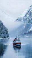 Winter Fjord Voyage Majestic Snow-Covered Mountains and a Red Boat photo