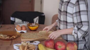 A woman is making pancakes on a table video