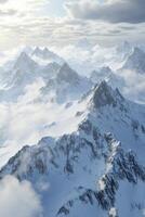 A large mountain range with snow and clouds photo