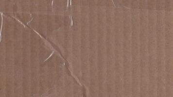 Animated tape marks on textured cardboard surface background video