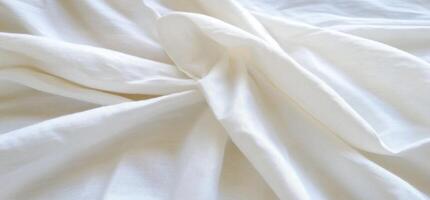 A close-up of soft, white fabric displaying gentle folds and texture. photo