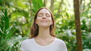 A woman is smiling in the middle of a forest photo