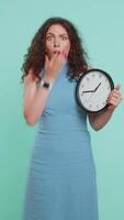 Young woman with anxiety checking time on clock, running late to work, being in delay, deadline video