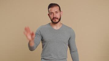 Young man say No hold palm folded crossed hands in stop gesture warning of finish prohibited access video