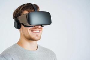 Young man enjoying virtual reality experience with headset in bright room photo
