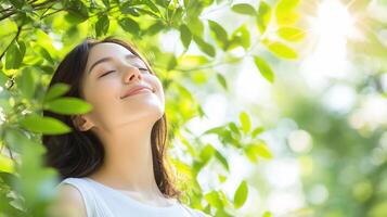 A woman is smiling while looking up at the sun photo