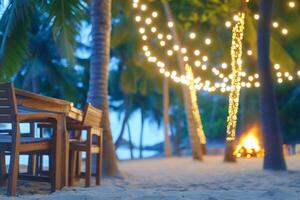 A table and chairs on the beach with string lights photo