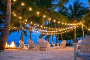 Beach chairs and palm trees with string lights photo