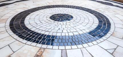 Circular mosaic pattern made of tiles in varying colors and sizes. photo