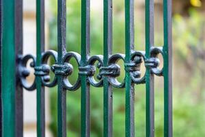 A close-up of a decorative iron gate with circular patterns. photo
