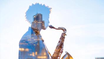 A silhouette of a saxophonist with a cityscape overlay. photo