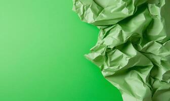 Crumpled green paper on a green background photo