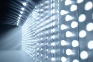 A bright, illuminated wall with beams of light creating a dramatic effect. photo