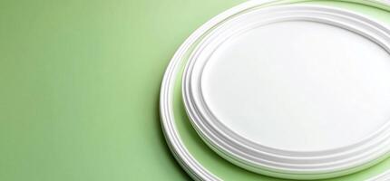 Minimalist white plates on a soft green background. photo