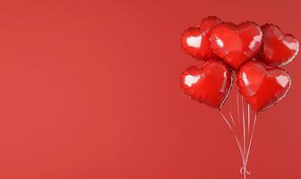 A cluster of shiny red heart-shaped balloons against a solid background. photo