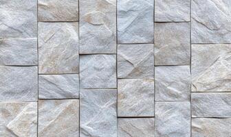 A close-up of textured stone tiles arranged in a pattern. photo