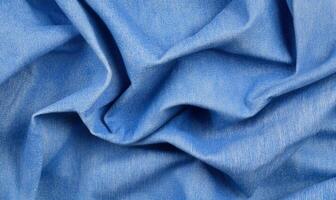 A close-up view of crumpled blue fabric showcasing texture and color. photo
