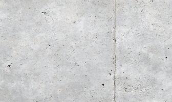 A close-up view of a textured concrete surface with subtle variations. photo