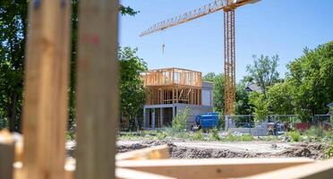 Construction site with a crane and wooden framework in progress. photo