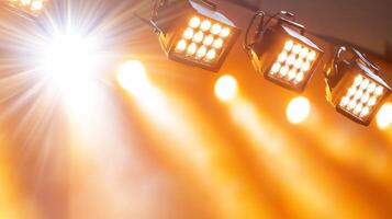 Bright stage lights illuminating a performance area with warm tones. photo