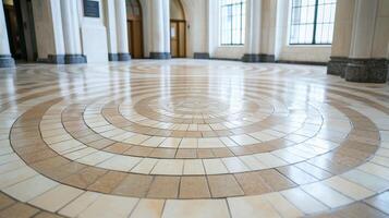 A close-up view of a circular tiled floor design in a spacious hall. photo