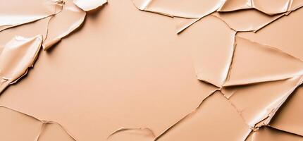 Abstract image of torn, peach-colored paper creating a textured background. photo