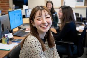 A smiling woman in an office setting with colleagues in the background. photo
