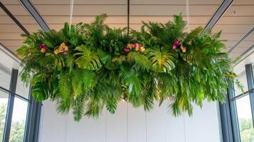 Prehistoric plants hang dramatically from the ceiling in a modern indoor setting with vibrant flowers photo
