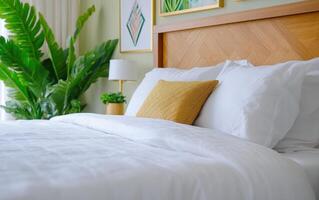 Cozy bedroom featuring lush giant ferns and a neatly made bed with white linens photo
