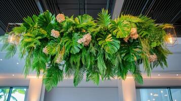 Prehistoric plants create a dramatic and lush overhead display in a modern indoor setting photo
