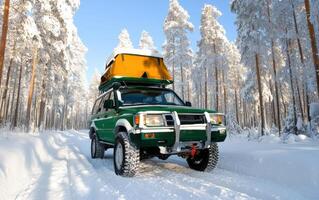Off-roading camping adventure in snow-covered forest with a green vehicle and roof-top camper photo