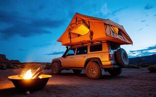 Camping under starry skies with off-road vehicle and rooftop tent at night by the campfire photo