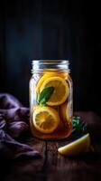 Refreshing lemon tea served in a mason jar with mint leaves and fresh lemons on a rustic wood table in natural light photo