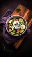 Fresh farm to table salad featuring cucumbers, colorful vegetables, and yogurt dressing presented on wooden surface photo