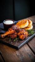 Crispy chicken with freshly baked biscuits and creamy dip served on a rustic wooden platter at a farm to table restaurant photo