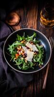 Fresh farm to table salad with arugula, pine nuts, and parmesan served in a rustic setting photo